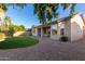 Landscaped backyard with a curved lawn and covered patio at 1384 E Morelos St, Chandler, AZ 85225