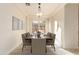 Bright dining room featuring a spacious table and light hardwood floors at 1384 E Morelos St, Chandler, AZ 85225
