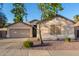 Single-story house with a two-car garage and well-maintained landscaping at 1384 E Morelos St, Chandler, AZ 85225