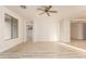 Bright living room with hardwood floors, ceiling fan, and large windows at 1384 E Morelos St, Chandler, AZ 85225