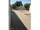 Backyard with paved patio, mature trees, and partial fence at 908 S Ocotillo Dr, Apache Junction, AZ 85120