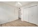 Bedroom with laminate flooring, double door closet and ceiling fan at 3321 E Crescent Ave, Mesa, AZ 85204