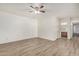 Bedroom with laminate flooring, ceiling fan, and access to bathroom at 3321 E Crescent Ave, Mesa, AZ 85204