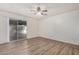 Bright bedroom with laminate wood flooring and a sliding glass door at 3321 E Crescent Ave, Mesa, AZ 85204