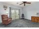 Bedroom with sliding door to patio, ceiling fan, and comfortable seating at 1951 N 64Th St # 10, Mesa, AZ 85205