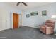 Bedroom with gray carpeting, ceiling fan and built-in wooden wardrobe at 1951 N 64Th St # 10, Mesa, AZ 85205