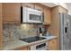 Kitchen detail showing cooktop, microwave, and granite counters at 9114 E Clubhouse Ct, Scottsdale, AZ 85266