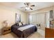 Spacious main bedroom with bay window and ceiling fan at 16419 W Chuparosa Ln, Surprise, AZ 85387