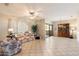 Bright living room with tile floors, sofa, and large window at 16419 W Chuparosa Ln, Surprise, AZ 85387