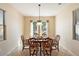 Dining room with wood table and chairs, and large windows at 16419 W Chuparosa Ln, Surprise, AZ 85387