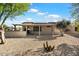 Covered patio, solar panels, and desert landscaping at 16419 W Chuparosa Ln, Surprise, AZ 85387