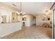 Open concept living area with kitchen and access to patio at 16419 W Chuparosa Ln, Surprise, AZ 85387