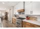 Modern kitchen with light wood cabinets, white upper cabinets and stainless steel appliances at 7210 S 255Th Ave, Buckeye, AZ 85326