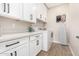 Laundry room with white cabinets, quartz countertop and washer/dryer at 7210 S 255Th Ave, Buckeye, AZ 85326