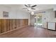 Dining area with wood paneling, wood flooring, and sliding glass doors at 4121 W Medlock Dr, Phoenix, AZ 85019