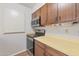 Stainless steel stove and microwave in galley style kitchen at 4121 W Medlock Dr, Phoenix, AZ 85019