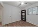 Bedroom with wood-look floors, built-in shelving, and access to bathroom at 4121 W Medlock Dr, Phoenix, AZ 85019