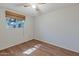 Bright bedroom with wood-look floors and window with blinds at 4121 W Medlock Dr, Phoenix, AZ 85019