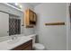 Bathroom with wood vanity, large mirror, and tub shower combo at 4121 W Medlock Dr, Phoenix, AZ 85019