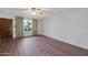 Living room with wood flooring and window with curtains at 4121 W Medlock Dr, Phoenix, AZ 85019