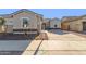 Single-story home with a front yard and driveway at 21033 E Camina Buena Vis, Queen Creek, AZ 85142