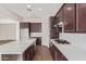 Spacious kitchen featuring an island, white countertops, and dark cabinetry at 21033 E Camina Buena Vis, Queen Creek, AZ 85142