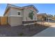 Single story home with neutral exterior and small front yard at 21033 E Camina Buena Vis, Queen Creek, AZ 85142