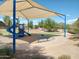 Community playground with shade structure and play equipment at 21033 E Camina Buena Vis, Queen Creek, AZ 85142