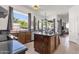 Eat-in kitchen with island, granite countertops, and dark wood cabinets at 5542 E Anderson Dr, Scottsdale, AZ 85254
