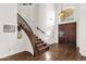 Curved staircase with dark wood railings and runner at 5542 E Anderson Dr, Scottsdale, AZ 85254