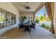 Outdoor patio with seating area, ceiling fan and views of the pool at 8575 E Sharon Dr, Scottsdale, AZ 85260