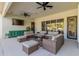 Covered patio with comfortable seating, a TV and access to the pool area at 8575 E Sharon Dr, Scottsdale, AZ 85260