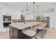 Modern kitchen with large island, stainless steel appliances, and stylish backsplash at 8575 E Sharon Dr, Scottsdale, AZ 85260