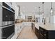 Modern kitchen with double ovens, white cabinetry, and stylish backsplash at 8575 E Sharon Dr, Scottsdale, AZ 85260