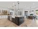 Modern kitchen with large island, farmhouse sink, and stainless steel appliances at 8575 E Sharon Dr, Scottsdale, AZ 85260