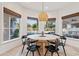 Bright breakfast nook with a large round table and pool view at 8575 E Sharon Dr, Scottsdale, AZ 85260