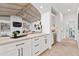Modern kitchen with white cabinets, quartz countertops, and stainless steel appliances at 8575 E Sharon Dr, Scottsdale, AZ 85260