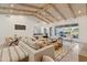 Living room boasts vaulted ceilings, neutral decor, and access to backyard at 8575 E Sharon Dr, Scottsdale, AZ 85260