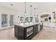 Gourmet kitchen with large island, stainless steel appliances, and access to backyard at 8575 E Sharon Dr, Scottsdale, AZ 85260