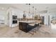 Modern kitchen with large island, stainless steel appliances, and open to Gathering room at 8575 E Sharon Dr, Scottsdale, AZ 85260