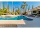 Inviting pool area with lounge chairs, umbrellas, and a built-in spa at 8575 E Sharon Dr, Scottsdale, AZ 85260
