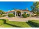 Elegant home exterior with landscaped grounds and a welcoming entryway at 8575 E Sharon Dr, Scottsdale, AZ 85260