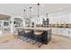 Open concept kitchen with large island and breakfast bar, white cabinetry, and a view to living area at 8575 E Sharon Dr, Scottsdale, AZ 85260