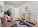 Sitting area with armchairs, storage shelving, and area rug at 8575 E Sharon Dr, Scottsdale, AZ 85260