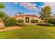 Beautiful Spanish style home with manicured lawn and landscaping at 8575 E Sharon Dr, Scottsdale, AZ 85260