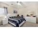 Modern bedroom with a queen bed, dresser, and large window at 13165 W Ventura St, Surprise, AZ 85379