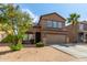 Two-story home with a two-car garage and desert landscaping at 13165 W Ventura St, Surprise, AZ 85379