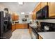 Well-equipped kitchen with stainless steel appliances and wood cabinets at 13165 W Ventura St, Surprise, AZ 85379
