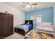 bedroom with crib, bed, and ample closet space at 13165 W Ventura St, Surprise, AZ 85379