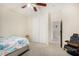 Spacious bedroom with a queen bed, carpet flooring, and double doors to another room at 13165 W Ventura St, Surprise, AZ 85379
